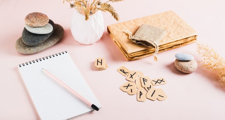 Scandinavian runes, notebook and pencil for writing on pink background web banner